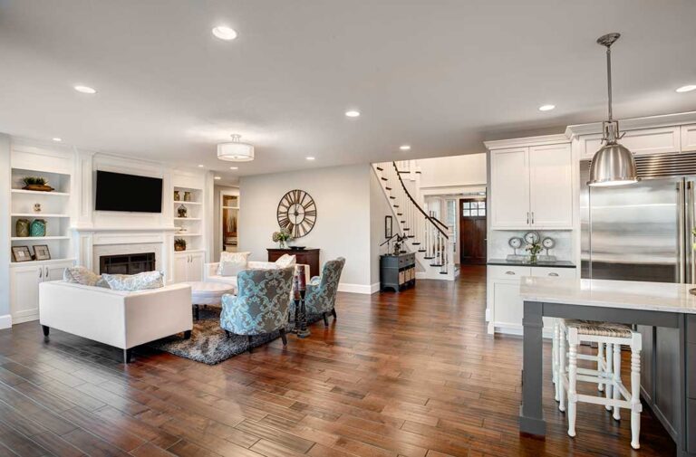 First-time buyers review home documents at a kitchen table beside inspection notes and a house key.